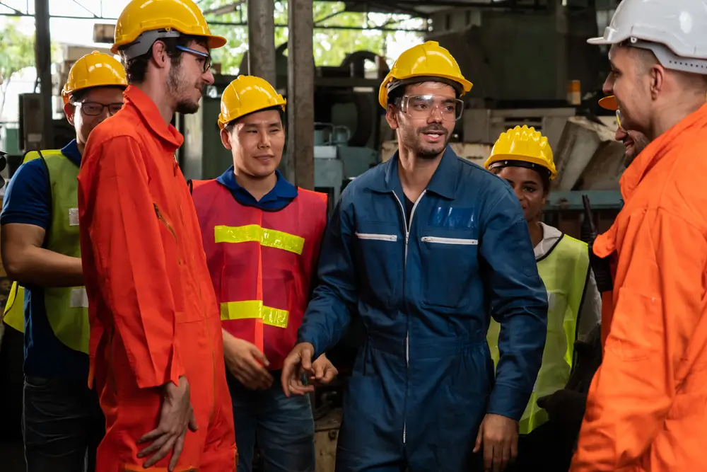 Employees discussing safety moments during a team meeting
