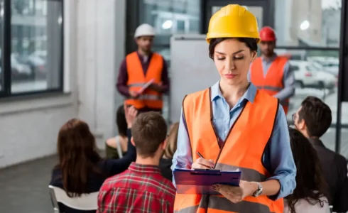 Daily pre-task safety planning meeting on construction site.