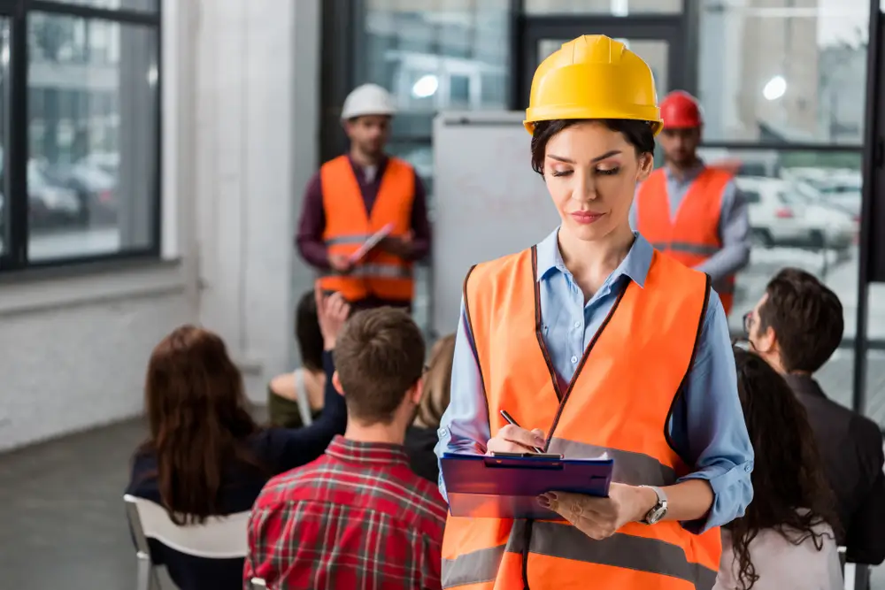 Daily pre-task safety planning meeting on construction site.